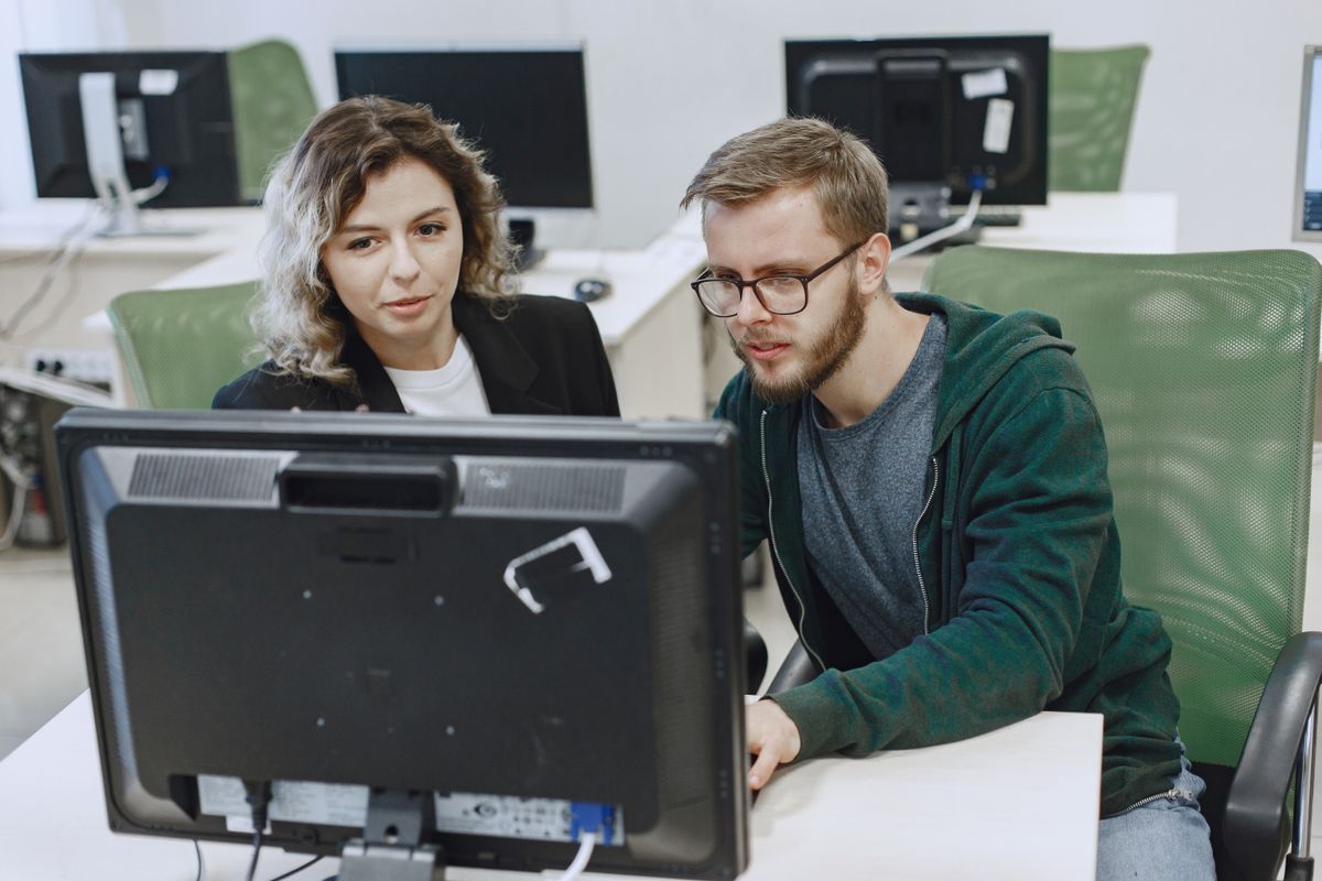 Two colleagues working together at a computer